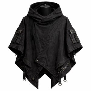 May include: Black hooded poncho with multiple pockets and straps. The dark-colored garment features a unique asymmetrical design with a hood, multiple pockets with zippers and buckles, and adjustable straps with metal D-rings.