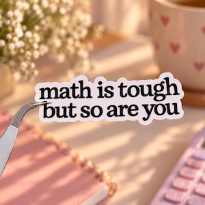 May include: A white die-cut sticker with a black border and the black text "math is tough but so are you" in a bold, rounded sans-serif font. The sticker is held by silver metal tweezers, showcasing the two-line message clearly.