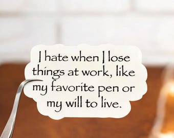 May include: A white sticker with black text that reads, "I hate when I lose things at work, like my favorite pen or my will to live." The sticker is held by a pair of silver tweezers.