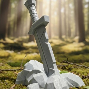 May include: A light gray sword with a faceted, geometric blade and a simple hilt, embedded firmly into a cluster of angular, light gray rocks. The object features a matte, textured finish and a solid, blocky construction throughout the design.