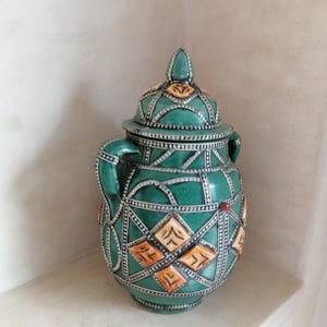 Traditional Handcrafted Pottery Jar with Metal, Camel Bone, and Red Stone Details"