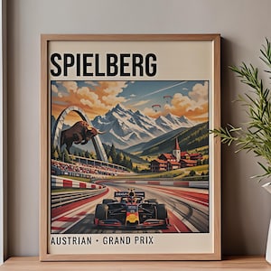 May include: Framed poster featuring a Formula 1 race car speeding on a track. The poster has the word "SPIELBERG" at the top and "AUSTRIAN GRAND PRIX" at the bottom. The background shows mountains, a bull, and a church.