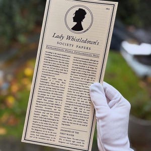 May include: A society paper titled "Lady Whistledown's Society Papers" with a silhouette of a woman. The paper, dated 1813, is held by a gloved hand and contains text about society news and extraordinary people.