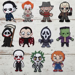 May include: A collection of eleven embroidered patches featuring stylized, cartoon-like depictions of various horror movie characters, including a masked slasher, a clown, a vampire, a grim reaper, a ghost-faced figure, and a green monster.