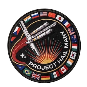 May include: A set of three ceramic mugs with a speckled, matte finish. The mugs are in shades of cream, light gray, and dark gray. Each mug has a simple, minimalist design and a rounded handle.