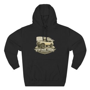 May include: Black hooded sweatshirt with a front graphic. The graphic features a vintage off-road vehicle with an American flag and the text "VINTAGE IRON OFFROAD". The design is in shades of beige and brown.