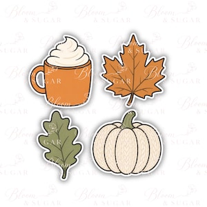 May include: A set of four stickers featuring an orange mug with white whipped cream, a brown maple leaf, a green oak leaf, and a cream-colored pumpkin with a textured knit pattern. Each sticker has a white border and a flat, graphic design.