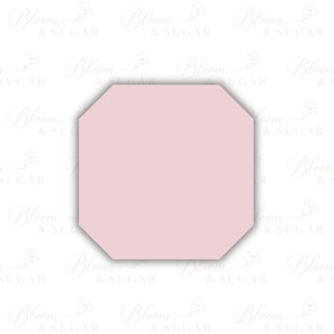 May include: A light pink, octagonal-shaped item, possibly a cake topper or decorative element. The item has a soft, pastel color and a clean, modern design. The background features a repeating pattern of the words "Bloom & Sugar".