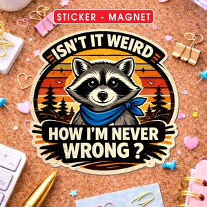 May include: A sticker or magnet featuring a raccoon with a blue scarf, set against a sunset backdrop with pine trees. The text reads "ISN'T IT WEIRD HOW I'M NEVER WRONG?" in a bold, vintage style. The words "STICKER - MAGNET" are at the top.