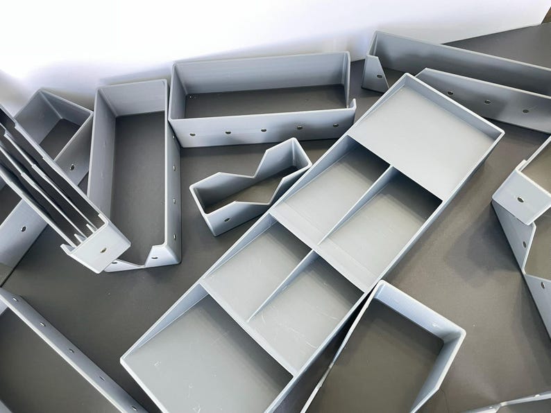 May include: A white ceramic mug with a black handle and the text "But First, Coffee" in a handwritten style. The mug is on a white surface. The mug is 4 inches tall.