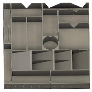 May include: A gray plastic organizer with multiple compartments of varying sizes and shapes. The organizer includes rectangular, square, and circular sections, designed for storing small items. The overall design is modular and functional.