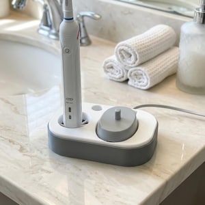 Suporte para escova de dentes elétrica - Base de carregamento Oral-B com bandeja coletora de gotas e compartimento para cabeças de escova.