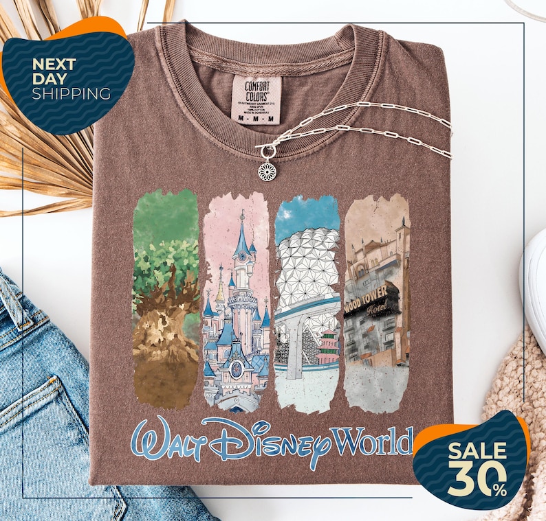 a brown t-shirt with a collage of four Disney World-themed illustrations, including a castle, a tree, a building, and a hotel. The t-shirt is displayed on a white background, and there are two sale signs indicating a 30% discount.