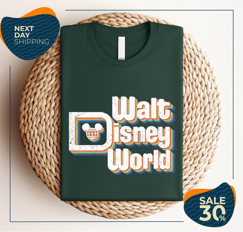 A green t-shirt with the text "Walt Disney World" printed on it, placed on a woven basket.