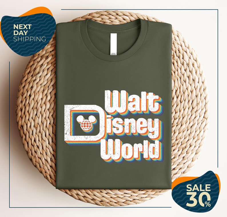 A green t-shirt with the text "Walt Disney World" printed on it, placed on a woven basket.