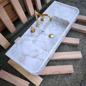 Elevate your space with a handcrafted marble sink from Turkey. Our collection includes calacatta marble sinks, carrera marble sinks, and stunning viola marble sinks, perfect for luxury bathrooms and kitchens. Explore the beauty of natural marble sinks today! Shop handmade marble sinks crafted from Turkish stone. Explore calacatta, carrara, and viola marble sinks for luxury bathrooms and kitchens. From moqui marble sinks to pergamon marble sinks. Handcrafted beauty and elegance in every detail.