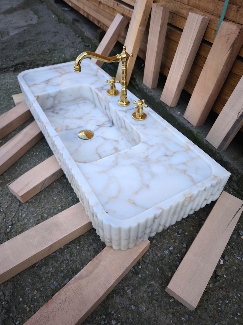 Discover the timeless appeal of a marble sink bowl or marble basin sink crafted with precision. From fluted marble sinks to ribbed marble sinks, each piece tells a story of craftsmanship and Turkish heritage. Customize your dream sink today! Elevate your bathroom with a custom marble sink. Choose from calacatta gold, lilac marble, and antique marble sink options, handcrafted in Turkey. Discover handcrafted marble sinks. Calcutta, viola, travertine, and arabescato marble sinks available.