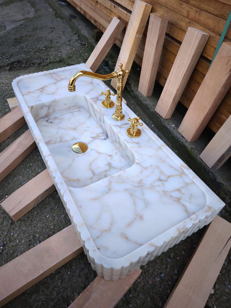Find your perfect bathroom marble sink with our extensive range of vessel sinks, wallmount sinks, and trough sinks. Featuring luxury stones like viola marble and calcutta marble, our sinks create breathtaking focal points. Elegant marble kitchen sinks, utility sinks, and workstation sinks available in custom designs. Turkish marble craftsmanship at its best. Transform your space with a marble wall sink or marble countertop sink. Featuring calacatta marble, travertine, and italian marble sinks.