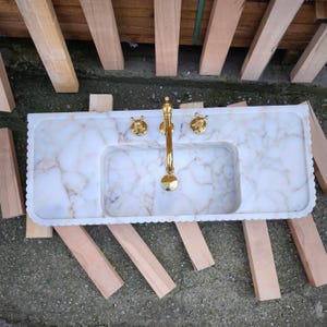 Looking for a unique marble sink? Our marble vessel sinks and marble countertop sinks are sculpted from premium stones like arabescato marble and calacatta gold marble. Add elegance to your bathroom with a true piece of art. Discover luxury marble vessel sinks, floating sinks, and integrated sinks. Perfect for elegant bathroom and kitchen upgrades. Custom orders available! Handmade marble sinks: calacatta sink, viola sink, carrara sink. Wall mounted, floating, and farmhouse marble sink designs.