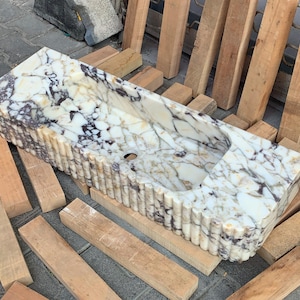 Handmade in Turkey, our marble kitchen sinks and utility sinks are carved from rich stones like ata marble and aegean marble. Whether you need a workstation sink or a charming farmhouse sink, our marble adds a luxurious touch. Transform your space with a marble wall sink or marble countertop sink. Featuring calacatta marble, travertine, and italian marble sinks. Luxury marble sinks made from aegean marble, carrara, and calcutta marble. Wall-mounted, pedestal, and floating styles available.