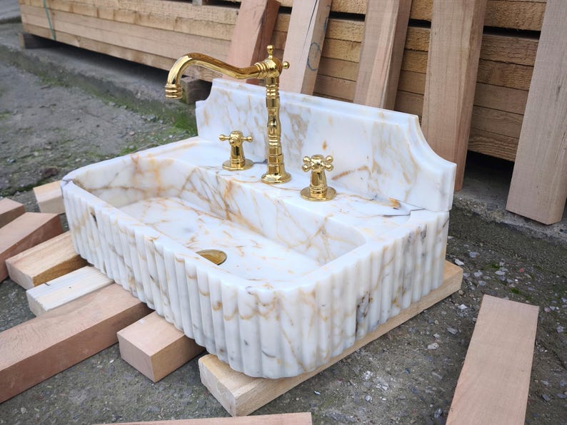 Transform your bathroom with a marble wall sink or a wall mounted marble sink. From modern calacatta sink styles to vintage-inspired portable sinks, we craft stunning options for every space with authentic Turkish marble. Bring timeless beauty with antique marble sinks and marble sink consoles. Each piece is carved from natural marble with expert Turkish artisanship. Explore calacatta monet marble sinks, carrera sinks, bathroom vessel sinks. Luxury, elegance, and lasting beauty in every piece.