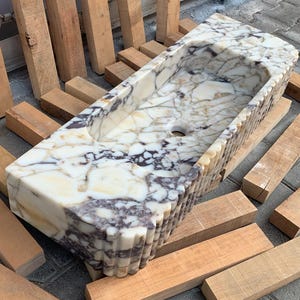 Searching for a custom marble sink? We offer integrated marble sinks and marble floating sinks made to order! Choose from lilac marble sinks, travertine marble sinks, and more to complete your perfect luxury bathroom renovation.
Handcrafted marble sinks from Turkey. Find marble basin sinks, vanity sinks, and custom sink tops in beautiful natural stones like viola marble.
Elevate your bathroom with a custom marble sink. From calacatta gold, antique marble sink options, handcrafted in Turkey.