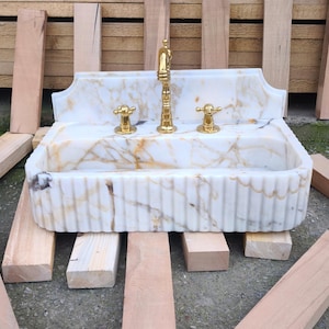 Find your perfect bathroom marble sink with our extensive range of vessel sinks, wallmount sinks, and trough sinks. Featuring luxury stones like viola marble and calcutta marble, our sinks create breathtaking focal points. Elegant marble kitchen sinks, utility sinks, and workstation sinks available in custom designs. Turkish marble craftsmanship at its best. Transform your space with a marble wall sink or marble countertop sink. Featuring calacatta marble, travertine, and italian marble sinks.