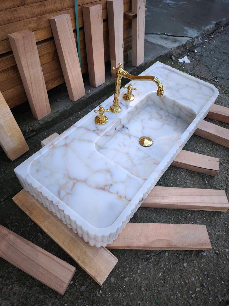 Handmade in Turkey, our marble kitchen sinks and utility sinks are carved from rich stones like ata marble and aegean marble. Whether you need a workstation sink or a charming farmhouse sink, our marble adds a luxurious touch. Transform your space with a marble wall sink or marble countertop sink. Featuring calacatta marble, travertine, and italian marble sinks. Luxury marble sinks made from aegean marble, carrara, and calcutta marble. Wall-mounted, pedestal, and floating styles available.