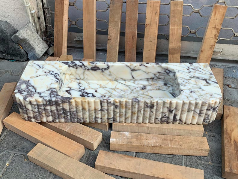 Looking for a unique marble sink? Our marble vessel sinks and marble countertop sinks are sculpted from premium stones like arabescato marble and calacatta gold marble. Add elegance to your bathroom with a true piece of art. Discover luxury marble vessel sinks, floating sinks, and integrated sinks. Perfect for elegant bathroom and kitchen upgrades. Custom orders available! Handmade marble sinks: calacatta sink, viola sink, carrara sink. Wall mounted, floating, and farmhouse marble sink designs.