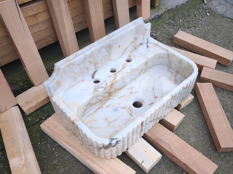 Explore the beauty of a calacatta viola marble sink or a carerra marble sink in your luxury project. Whether you need a pedistal sink, console sink, or laundry sink, our handcrafted natural marble sinks bring timeless elegance. Upgrade your vanity with a marble sink top or marble basin sink. beautiful calacatta, lilac, and carrara marble options. Luxury marble sinks for every space: bathroom, kitchen, laundry. Explore wall mount marble sinks, vessel sinks, and integrated marble sinks.