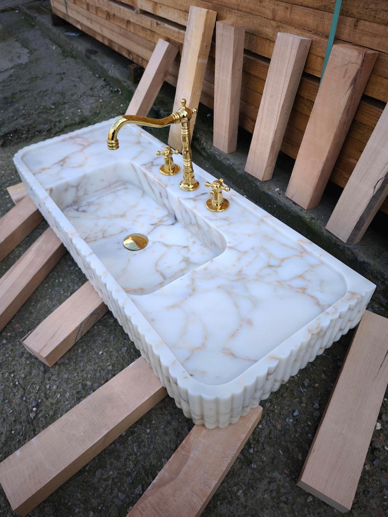 Bring antique charm to your home with our antique marble sinks and marble sink consoles. Each marble sink antique piece is a tribute to classic craftsmanship, blending history with the enduring beauty of stone marble sinks. Shop fluted marble sinks, ribbed marble sinks, marble vessel sinks. Handmade from the finest natural marbles for stunning home designs. Handcrafted marble sinks from Turkey. marble basin sinks, vanity sinks, and custom sink tops in beautiful natural stones like viola marble.