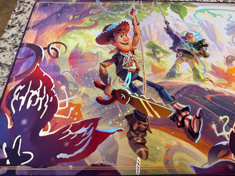 May include: A vibrant playmat featuring a colorful illustration of Woody and Buzz Lightyear from Toy Story. Woody is sliding down a rope, while Buzz is swinging on a rope in a forest setting. The mat has a purple border and a detailed, artistic design.