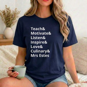 May include: Navy blue t-shirt with white text listing the words "Teach & Motivate & Listen & Inspire & Love & Culinary & Mrs Estes". The shirt is a crew neck style.