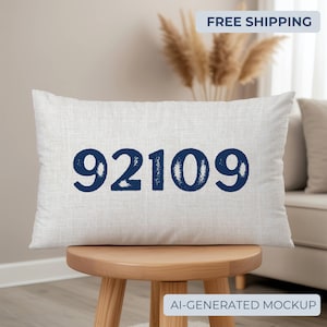 May include: A rectangular throw cushion with a light grey, textured fabric cover. The centre of the cushion features the dark navy blue numbers 92109 printed in a bold, sans-serif font with a slightly distressed, weathered texture.