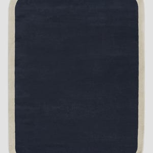 May include: A rectangular area rug with rounded corners featuring a solid dark navy blue center panel surrounded by a wide, solid light beige border. The rug has a uniform, flat-pile texture throughout the entire surface area of the piece.