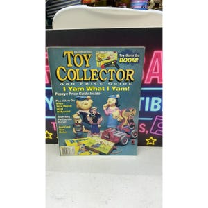 以下が含まれることがあります： 1993年12月号の雑誌「Toy Collector and Price Guide」。表紙にはポパイのキャラクターが描かれています。表紙には「Toy Collector and Price Guide」、「I Yam What I Yam!」、「Toy Guns Go BOOM!」という文字と、様々なポパイのおもちゃが掲載されています。