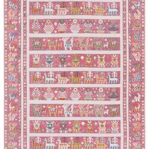 Könnte beinhalten: Ein rechteckiger, rosa Teppich mit einem detaillierten Muster. Der Teppich zeigt Reihen stilisierter Tier- und Blumenmotive in verschiedenen Farben, darunter Weiß, Gelb und Blau, vor einem rosa Hintergrund. Der Rand ist hellrosa mit einem sich wiederholenden geometrischen Design.