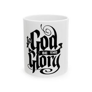 May include: White ceramic mug featuring the phrase "to God be the Glory" in black script. The mug has a glossy finish and a standard handle. The text is in a decorative, stylized font.