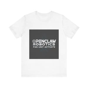 May include: White t-shirt with a dark gray square graphic. The graphic features the text "OPENCLAW ROBOTICS FAN UNIT ACTIVATE" in white, along with a stylized logo. The shirt is a casual wear item.