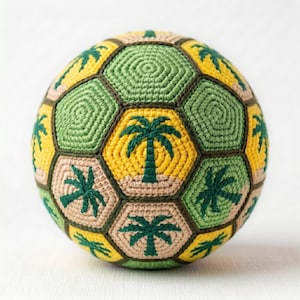 May include: A handmade, crocheted ball featuring a soccer ball design. The ball is composed of green, yellow, and tan hexagonal panels, each with a palm tree motif. The ball is a unique, decorative item.