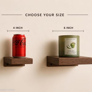 May include: Two dark brown wooden wall shelves labeled CHOOSE YOUR SIZE. The left shelf is 4 inches wide with a red Coca-Cola Zero Sugar can on top. The right shelf is 6 inches wide with a green Bath & Body Works Spring Apple candle on top.