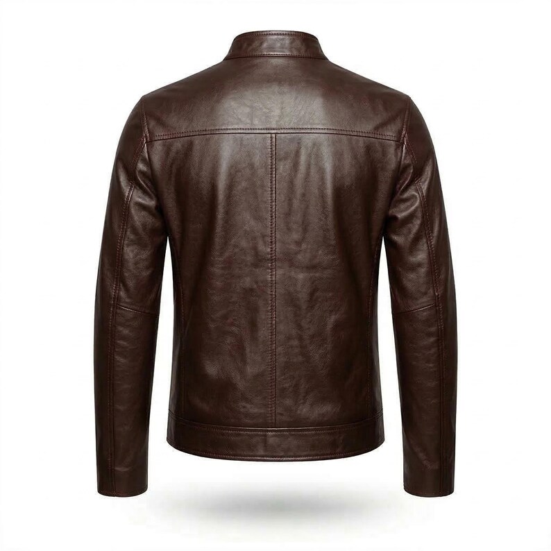 May include: A brown leather jacket with a stand-up collar. The back view of the jacket shows vertical stitching details and a tailored fit. The jacket has long sleeves and a classic design.