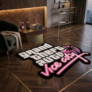 May include: A custom-shaped area rug featuring the Grand Theft Auto Vice City logo. The design includes bold white block lettering for Grand Theft Auto and pink neon-style script for Vice City, accented by a black palm tree silhouette on a pink sun.