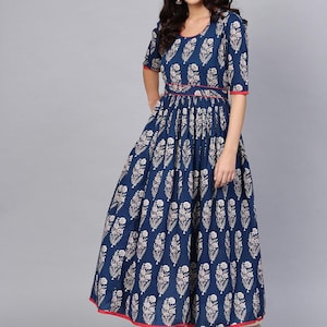 May include: A navy blue maxi dress with a white floral pattern. The dress features short sleeves, a round neckline, and a red trim along the neckline, sleeves, and hem. The waist is cinched with a red band.