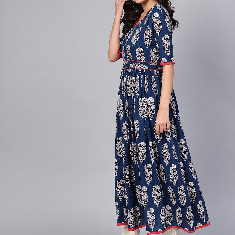 May include: A navy blue maxi dress with a white floral pattern. The dress features short sleeves, a V-neckline, and red trim along the neckline, waist, and hem. The dress is floor-length and has a flowing silhouette.