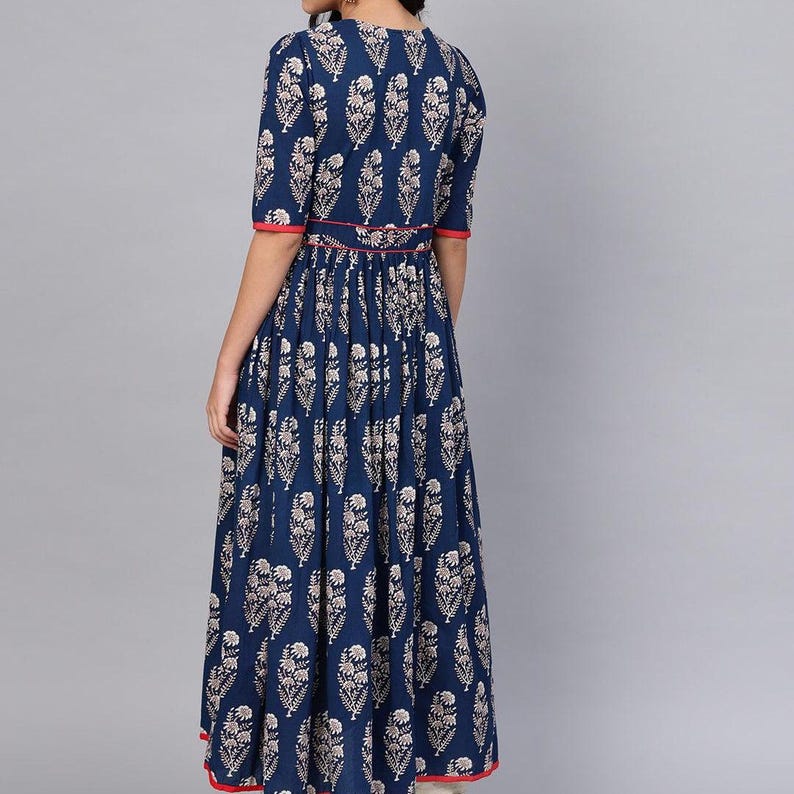 May include: A navy blue dress with a white floral pattern. The dress has short sleeves, a round neckline, and a red trim along the sleeves and waist. The dress is floor-length and has a pleated skirt.