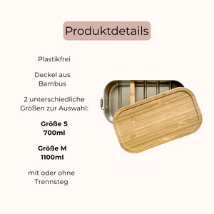 May include: A rectangular metal lunch box with a removable bamboo lid and an internal divider. The text on the image reads: Produktdetails, Plastikfrei, Deckel aus Bambus, 2 unterschiedliche Gr&ouml;&szlig;en zur Auswahl: Gr&ouml;&szlig;e S 700ml, Gr&ouml;&szlig;e M 1100ml, mit oder ohne Trennsteg.