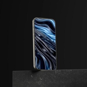 May include: A silver smartphone with a screen displaying a blue and black abstract design. The phone is positioned upright, showcasing its sleek design and the vibrant display against a dark background.