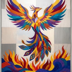 May include: A large rectangular wall quilt featuring a geometric phoenix with wings spread wide, rendered in vibrant shades of yellow, orange, red, purple, and blue. The bird rises above stylised flames and waves in matching colours on a grid background.