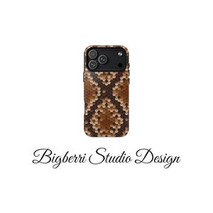 May include: A smartphone case featuring a brown and tan hexagonal pattern that mimics a snake skin texture. The case has a black camera module cutout with three circular lenses and a flash. The text Bigberri Studio Design is below the case.